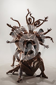 The group of modern ballet dancers. Contemporary art ballet. Young flexible athletic men and women.
