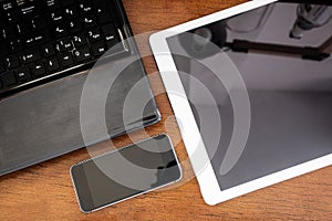 Group of modern electronic devices, computer laptop, digital tablet and mobile smart phone on wooden table