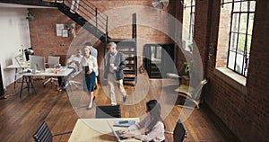 Group of modern executive business people walking together to corporate conference room for morning meeting with manager