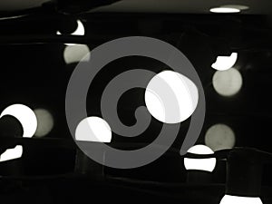 Group of modern LED light bulbs ball shape randomly install in black and white selective focus for background