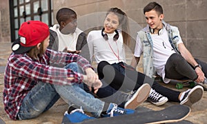 Group of modern teens chatting in the yard