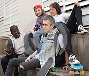 Group of modern teens chatting in the yard