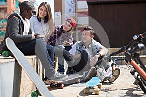 Group of modern teens chatting in the yard