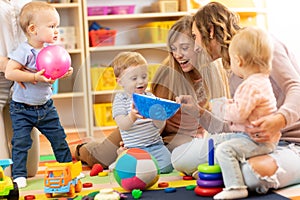 Group of moms with their babies in nursery