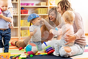 Group of moms with their babies at playgroup