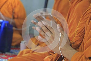 Group of monks while they put the palms of the hands together in salute