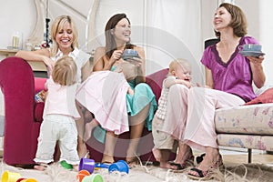 Group of mothers playing at home with toddlers photo