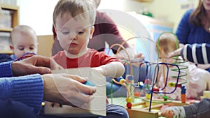 Group Of Mothers And Toddlers Playing With Toys