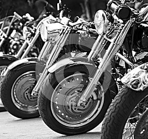 group motorbikes parked together on outdoors background.