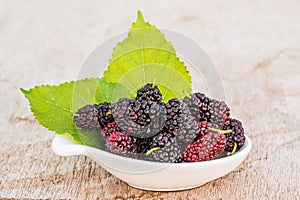 Group of mulberries isolated on wood.