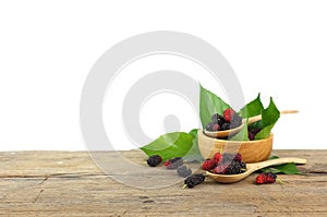 Group of mulberries on wooden table isolated on white background