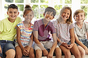 Group Of Multi-Cultural Children On Window Seat Together photo