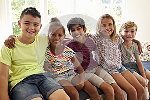 Group Of Multi-Cultural Children On Window Seat Together