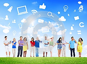 Group Of Multi-Ethnic People Social Networking Outdoors And Related Symbols Above