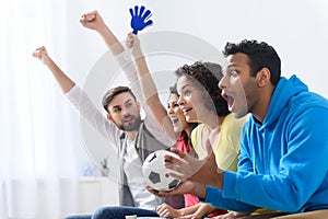 Group of multi national football fans cheering