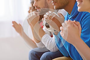 Group of multi national football fans cheering