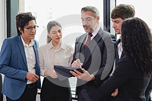 Group of multicultural business people standing in modern office