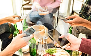 Group of multicultural friends having fun on mobile cell phones