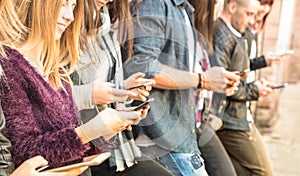 Group of multicultural friends using smartphone at university co