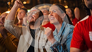 Group of Multicultural Friends Watching a Live Soccer Match in a Sports Bar. Focus on Beautiful