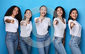 Group Of Multicultural Ladies Pointing Fingers At Camera, Blue Background