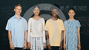 Group of multicultural teenager looking at camera at blackboard. Edification.