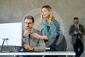 Group of multiethnic business people analyzing data using computer while working in the office