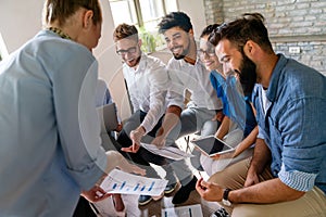 Group of multiethnic business people brainstorming, analyzing financial reports in office