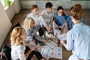 Group of multiethnic business people brainstorming, analyzing financial reports in office