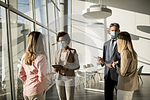 Group of multiethnic business people have a meeting and working in office while wear mask as protection from corona virus