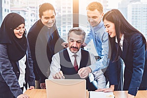 Group of multiethnic business people trainning by executive senior boss in modern office with laptop computer. Startup team