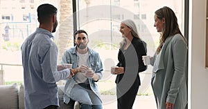 Group of multiethnic colleagues talking during coffee break