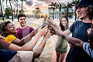 Group of multiethnic happy friends having party outside celebrating toasting beer bottles on sunset