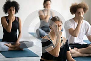 Group of multiethnic people doing yoga practice Alternate Nostril Breathing