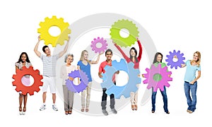 Group of Multiethnic People Holding Colorful Cogs