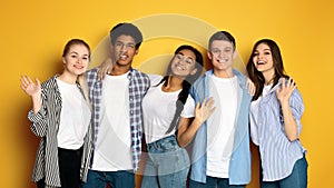 Group of Multiethnic Teenagers Standing Together, Waving at Camera