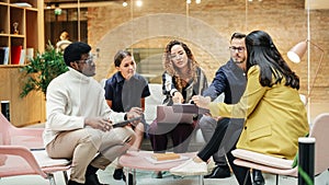 Group of Multiethnic Young People Strategizing in a Conference Room at Office. Female Supervisor