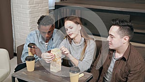 Group of multinational friends playing block removal game in the living room home