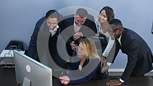 Group of multiracial business people looking at a screen of laptop, having video conference