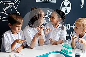 Group of multiracial diverse kids carrying out a science experiment in lab