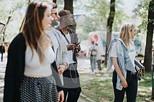 Group of multiracial friends enjoying a sunny walk in the park on a weekend