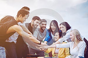 Group of multiracial friends hand putting with stack of handshaking and showing successful teamwork together,Enjoying backpacking