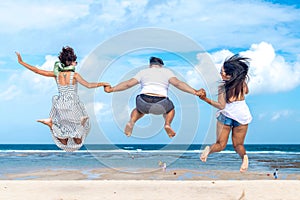 Group of multiracial friends having fun on the beach of tropical Bali island, Indonesia.