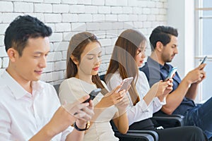 Group of multiracial friends using cellular, Teenagers texting mobile phone messages, Concept of students addiction to social