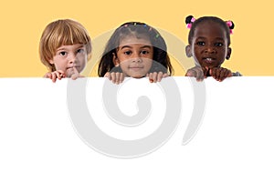 Group of multiracial kids portrait with white board photo