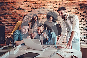 Group of multiracial office workers in casual clothes talking about tasks and plans