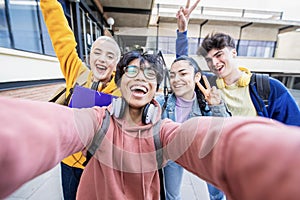 Group of multiracial students taking selfie picture at school