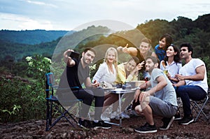 Group of multiracial traveler selfie with mobile phone at nature together,Happy and smiling,Enjoying backpacking concept