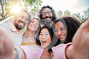 Group of multiracial young people smiling and taking a selfie together. Close up portrait of happy asian teenage woman