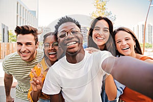 Group of multiracial young student people smiling and taking a selfie together. Close up portrait of happy african